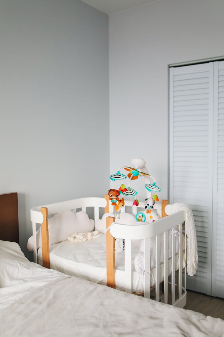 White Crib In Bright Bedroom