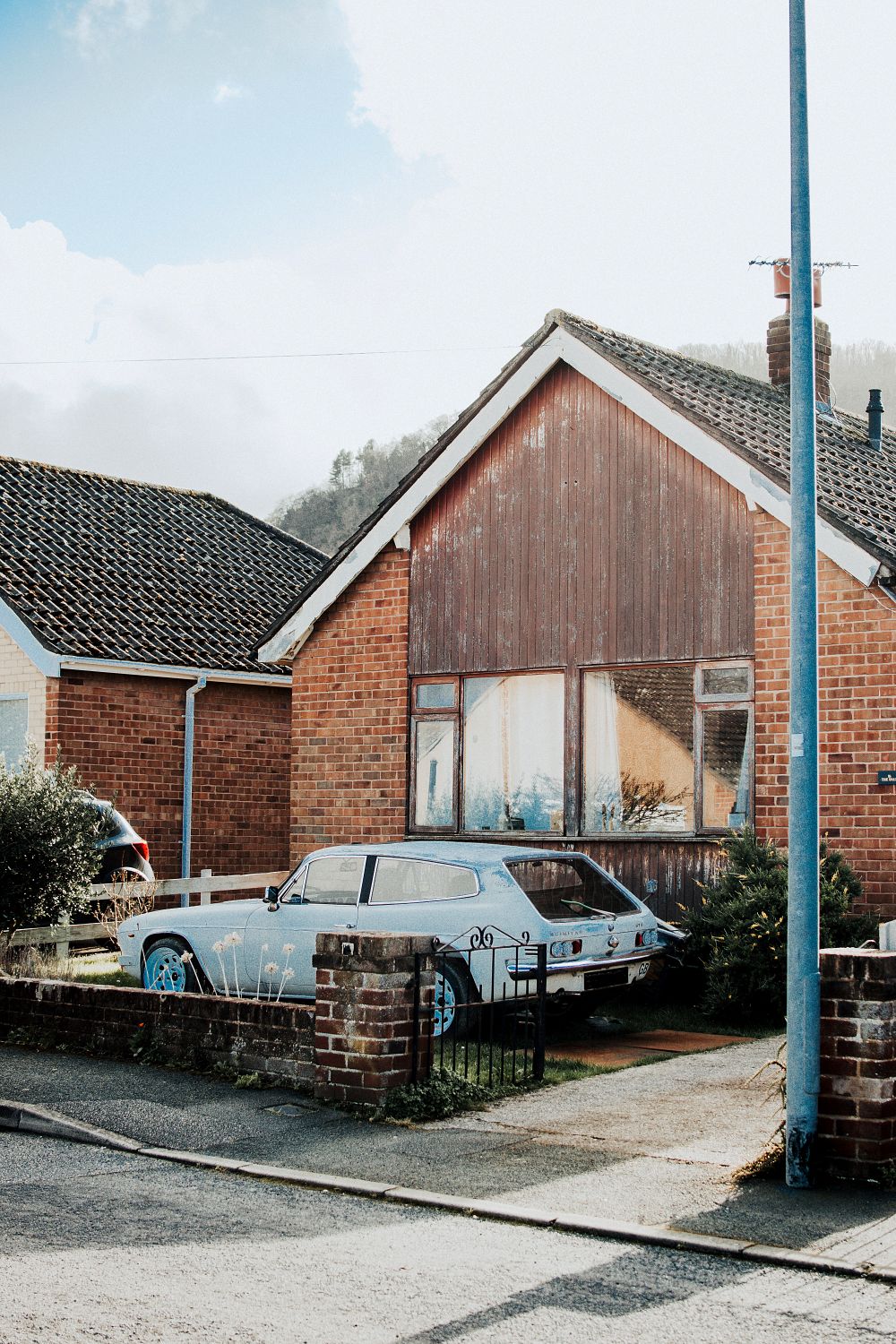 A Car Parked Beside the Brown House · Free Stock Photo