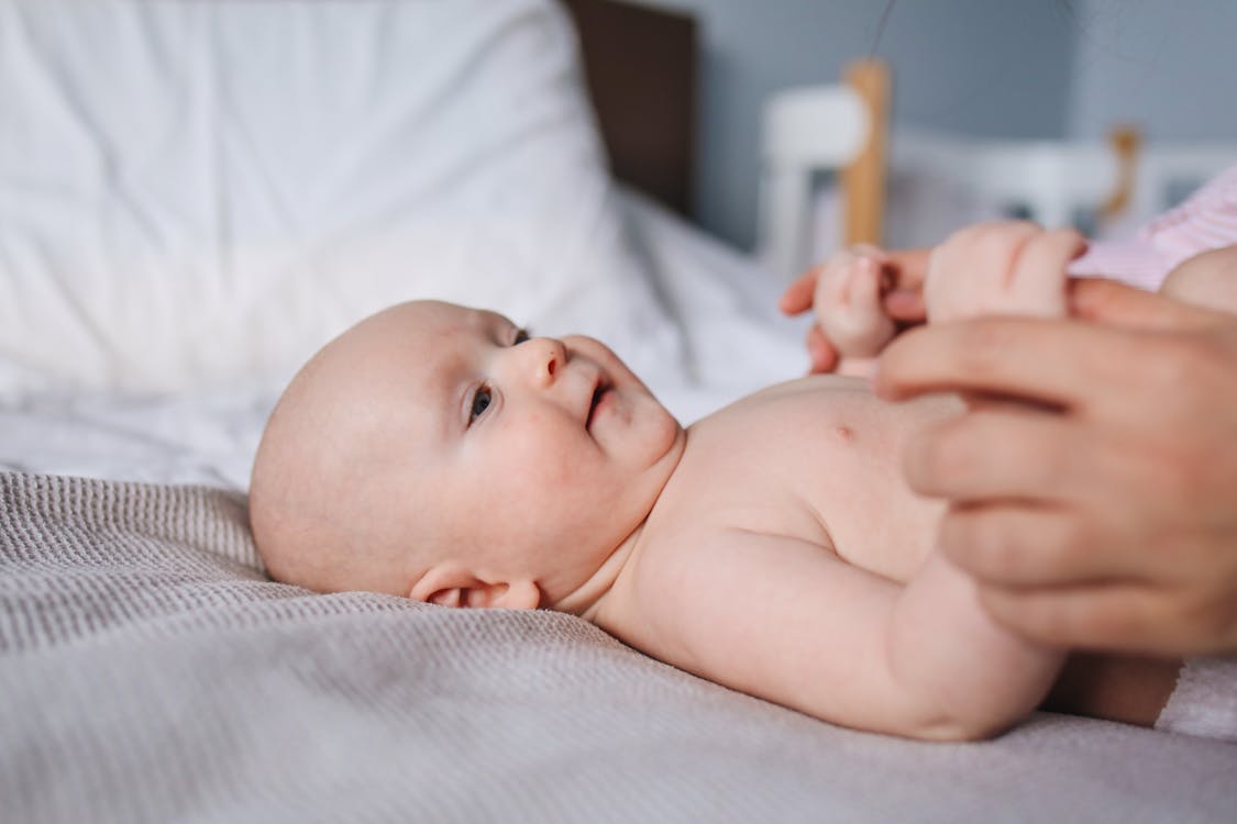 Free Close-Up Photo of Baby Laying On Bed Stock Photo