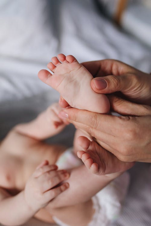 Person Holding Baby's Feet