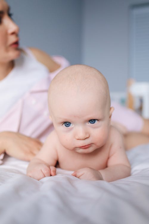Free Photo of Baby Laying On Bed Stock Photo