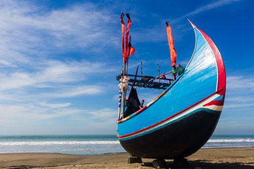 Free A vibrant traditional fishing boat under a clear blue sky on Cox's Bazar beach, Bangladesh. Stock Photo