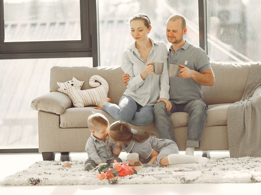 Parents and children relaxing together on a sofa in a bright living room