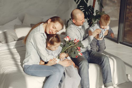 Free Happy family resting on bed during weekend Stock Photo