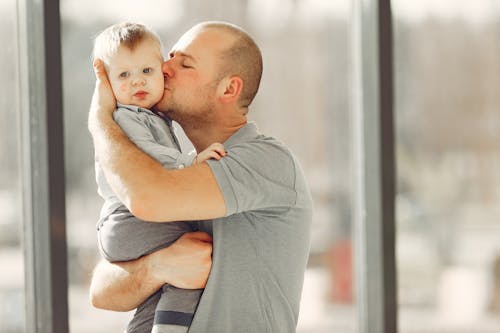 Free Photo of Guy Kissing A Baby Stock Photo