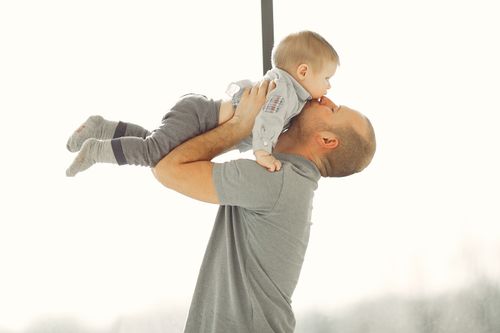 Free A father lovingly lifts his baby, showcasing a tender parent-child bond. Stock Photo