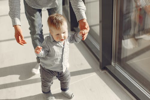 Free Little Baby Boy Standing And Learning To Walk Stock Photo
