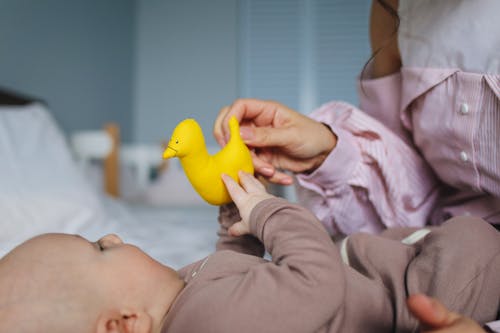 Free Mommy Playing Rubber Duckie With Her Baby Stock Photo