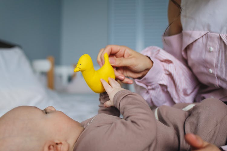 Mommy Playing Rubber Duckie With Her Baby