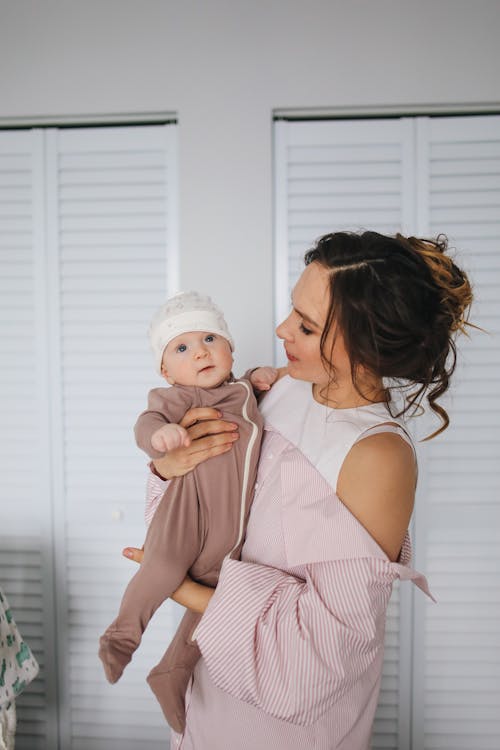 Free Mother Carrying Her Cute Baby Stock Photo
