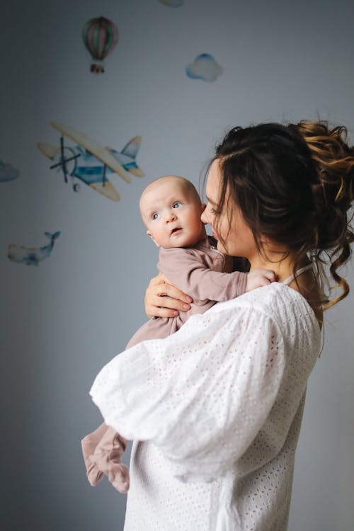 Free Mother Carrying Her Cute Baby Stock Photo