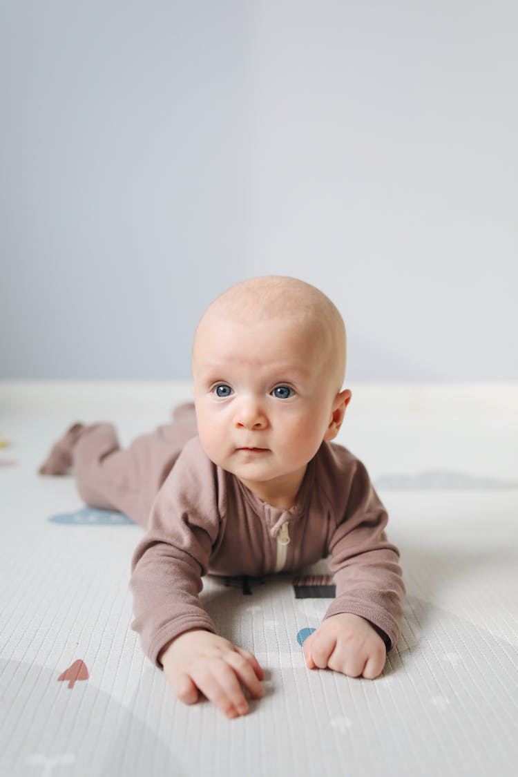 Photo Of Baby Lying On Bed