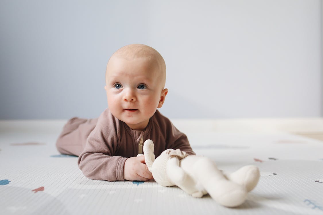 Free Photo of Baby Lying On Bed Stock Photo
