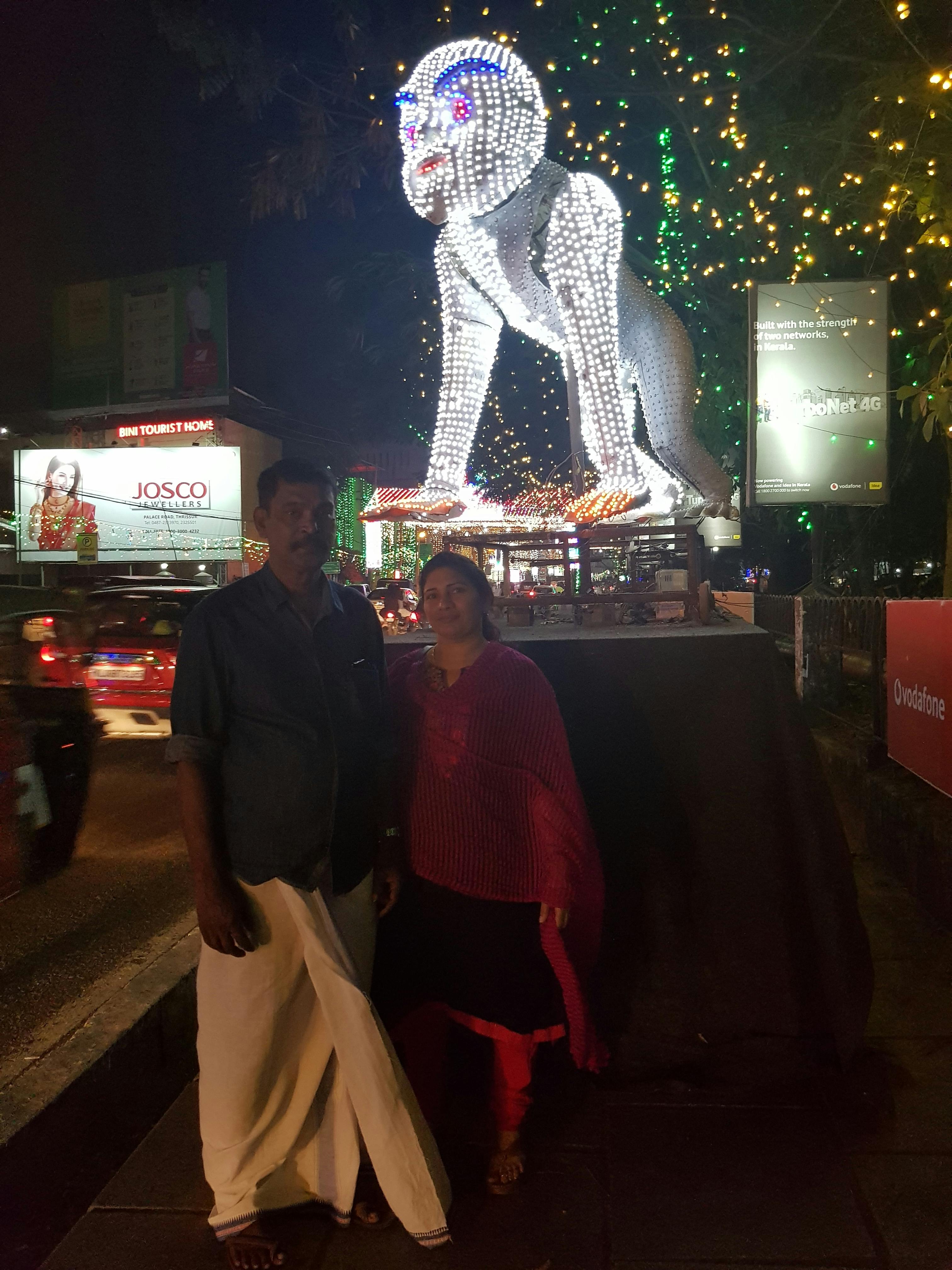 Parent carrying happy baby in a structured baby carrier outdoors