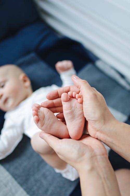 Person Holding Baby's Feet