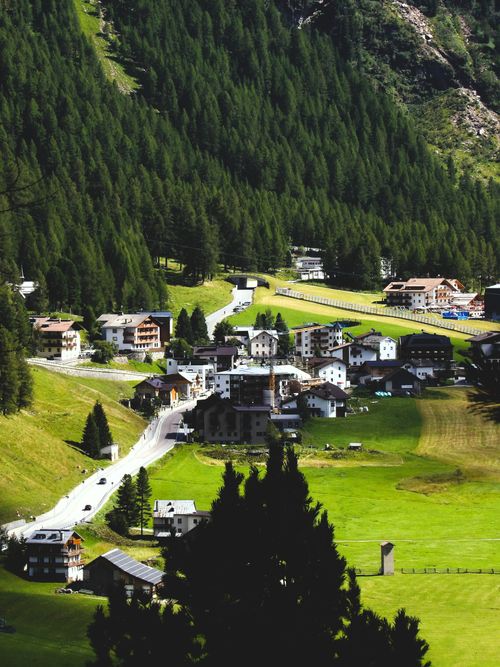 Free Charming alpine village nestled in Trentino-Alto Adige, surrounded by lush greenery. Stock Photo