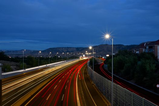 Vibrant long exposure captures night traffic lights on highway, Alcalá de Henares.