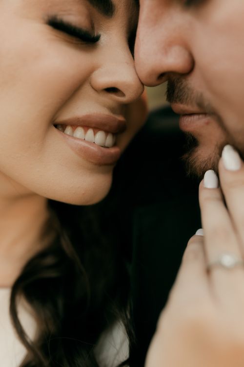 Free A tender close-up shot capturing an intimate moment between a smiling couple, highlighting romance. Stock Photo