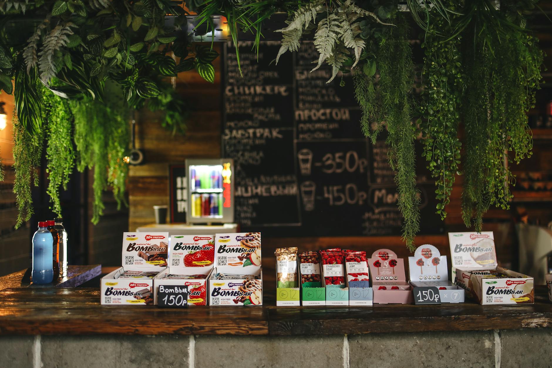 Bar with sweets and water decorated with plants