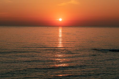 Free Breathtaking view of sunset reflecting on the tranquil water at Cua Tung, Vietnam. Stock Photo