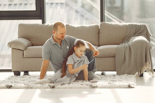 Man In Gray Polo Shirt Sitting On Carpet