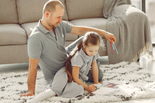 Man In Gray Polo Shirt Beside His Daughter