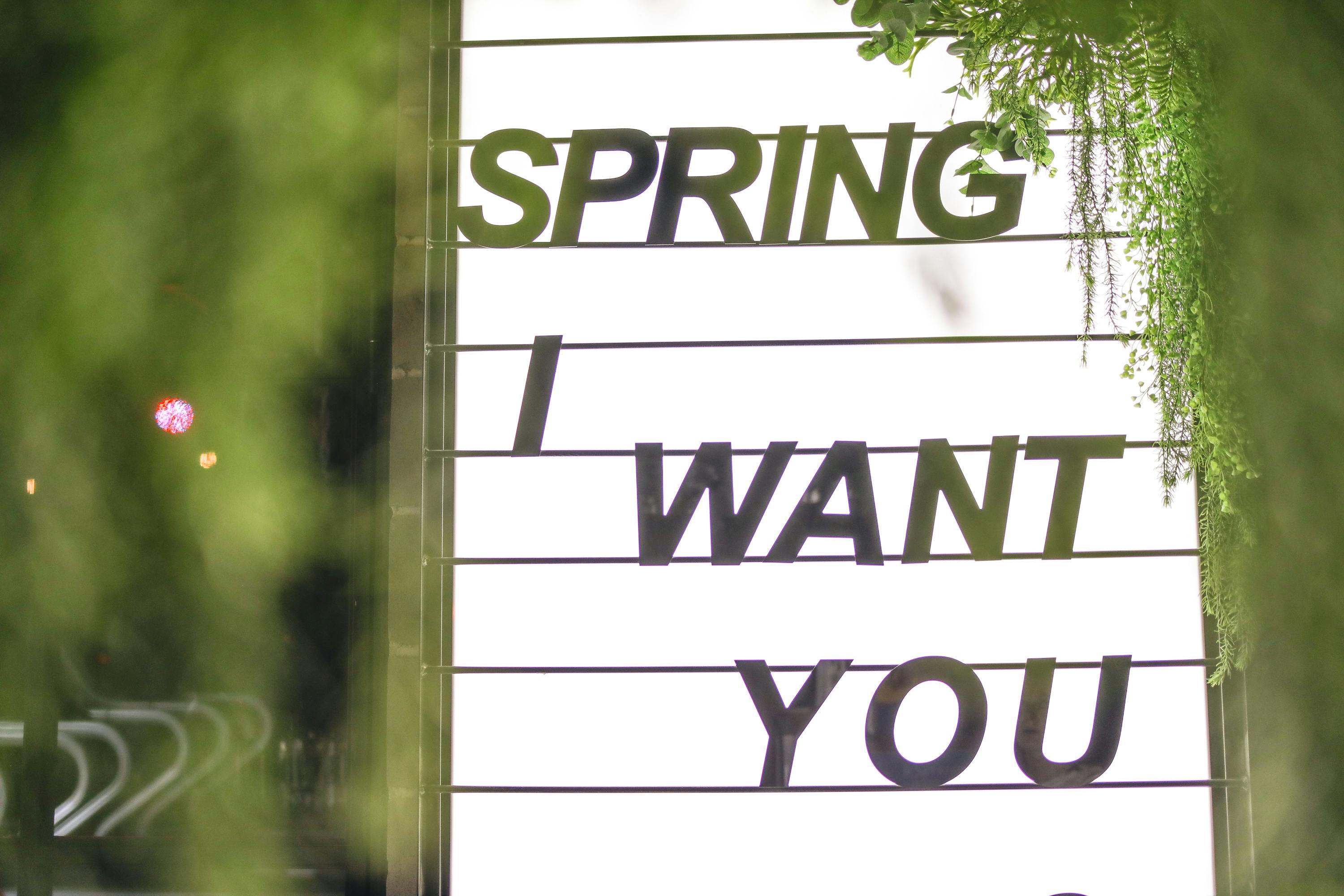 luminous sign with inscription among greenery