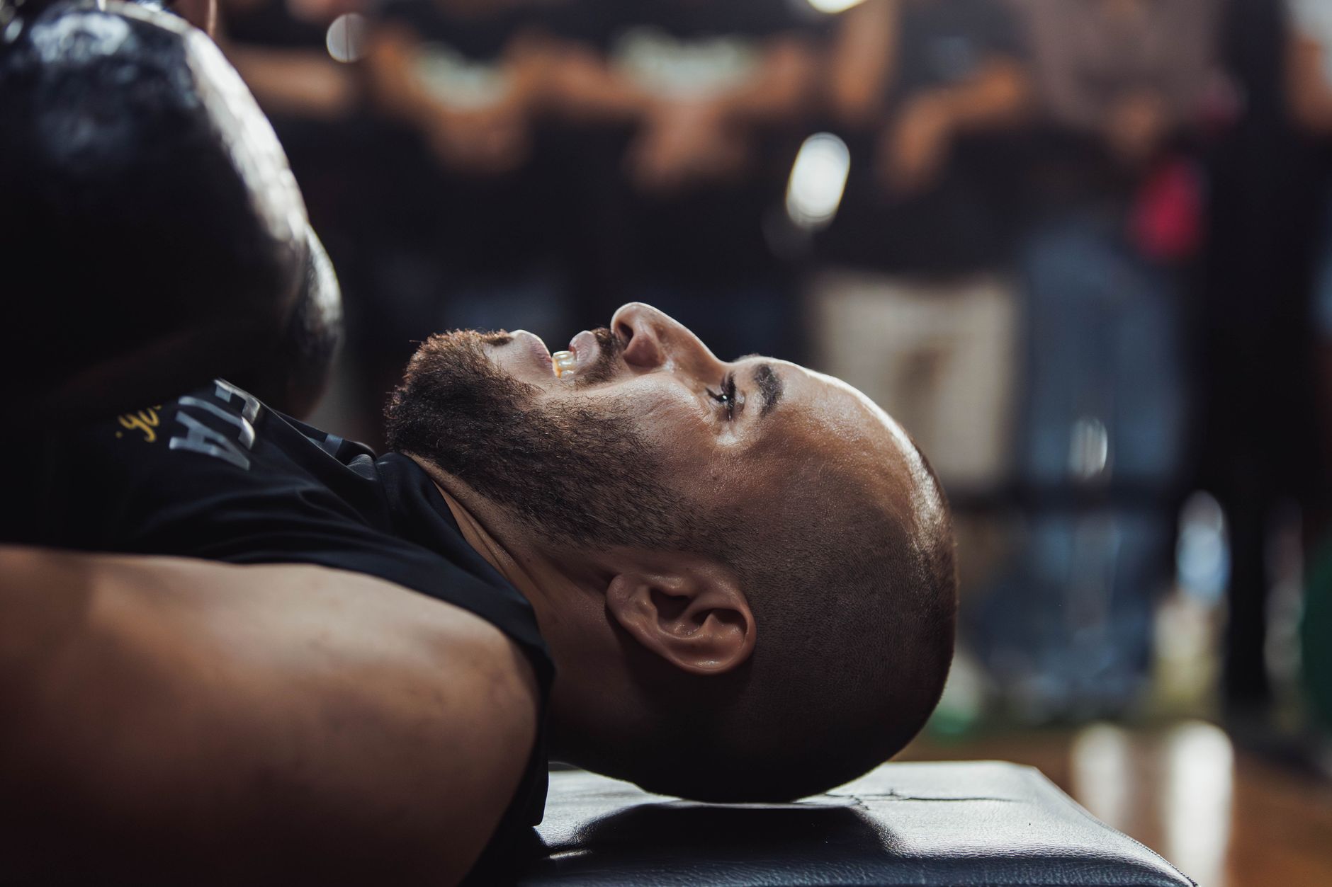 long covid recovery timeline natural support — A focused view of a man lying down in a gym setting, indicating post-exercise relaxation.