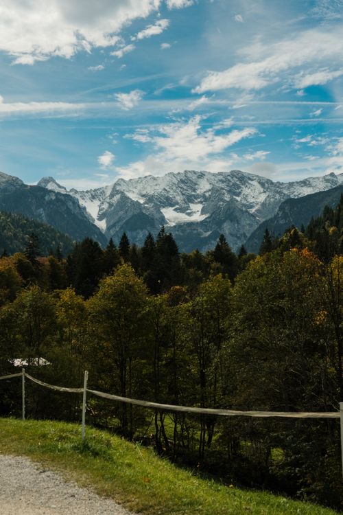Free Majestic snow-capped peaks and lush forests in the Bavarian Alps during autumn. Stock Photo