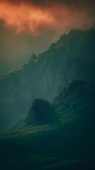 Captivating view of a misty mountain landscape during sunrise in Chechnya, Russia.