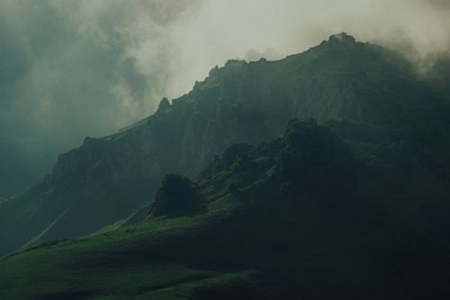 Free Dramatic mist-covered mountains in the Chechen Republic, Russia, evoke mystery and tranquility. Stock Photo
