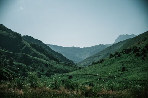 Free Breathtaking view of green mountains in Chechnya, Russia, captured on a clear summer day. Stock Photo