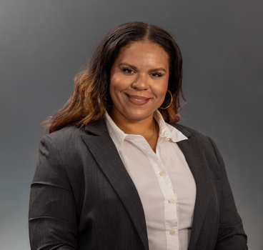 Portrait of a smiling professional woman in a grey suit. Ideal for business and corporate themes.