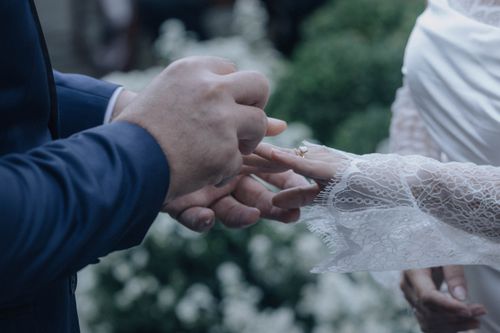 Free A close-up of a couple exchanging rings during a wedding ceremony, showcasing love and commitment. Stock Photo