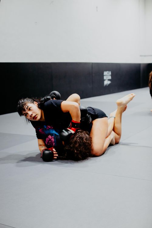 Free Two women engage in a competitive grappling match at a martial arts academy in Buenos Aires. Stock Photo