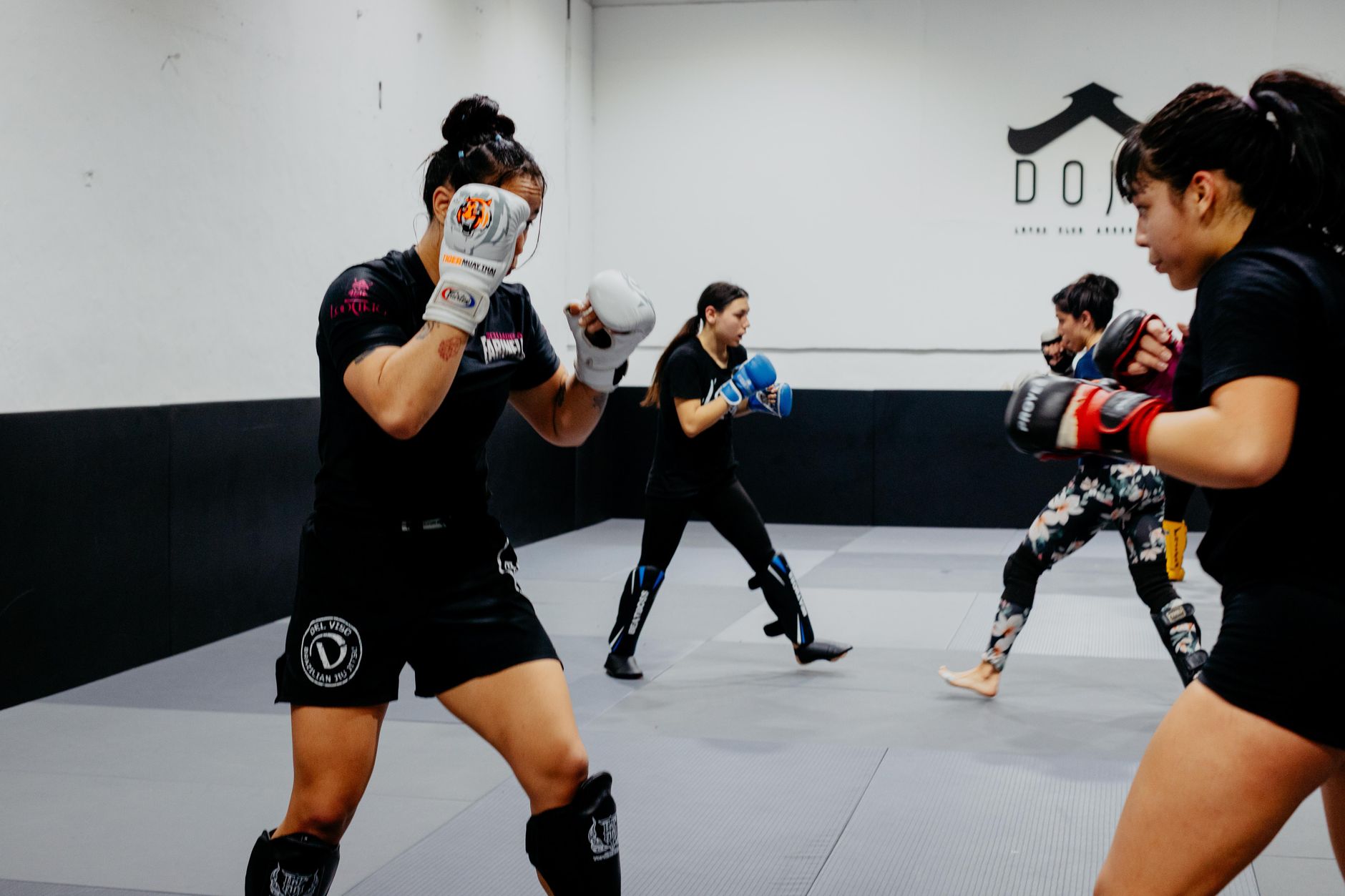 Group of young adults practicing martial arts in an indoor dojo in Buenos Aires.