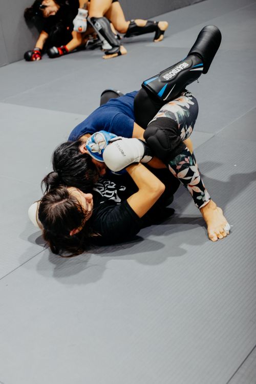 Free Martial artists engage in a grappling session at an indoor academy in Buenos Aires. Stock Photo