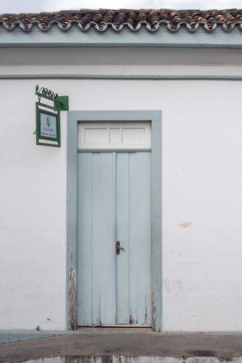 Free A vintage wooden door in historic Santa Luzia, Minas Gerais, Brazil, showcasing colonial architecture. Stock Photo