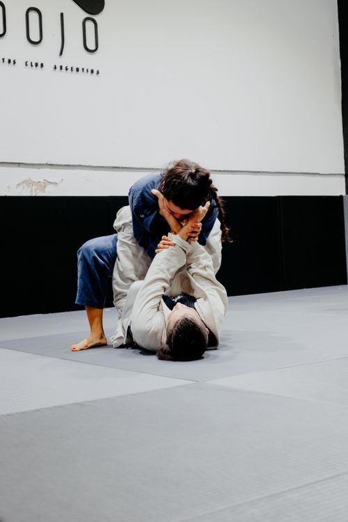 Free Two martial artists practice jiu-jitsu grappling techniques inside a Buenos Aires dojo. Stock Photo