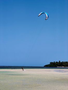 Experience thrilling kitesurfing against the backdrop of Samaná's stunning beaches and blue skies.