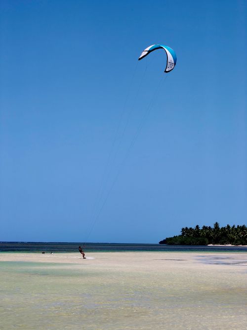 Free Experience thrilling kitesurfing against the backdrop of Samaná's stunning beaches and blue skies. Stock Photo