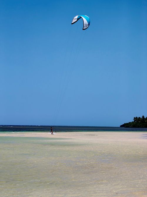 Free Kiteboarder enjoying the serene beaches of Samaná, Dominican Republic. Stock Photo