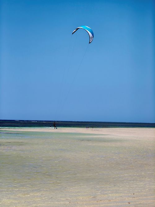 Free Kiteboarder enjoying a sunny day on Samaná beach, Dominican Republic. Stock Photo