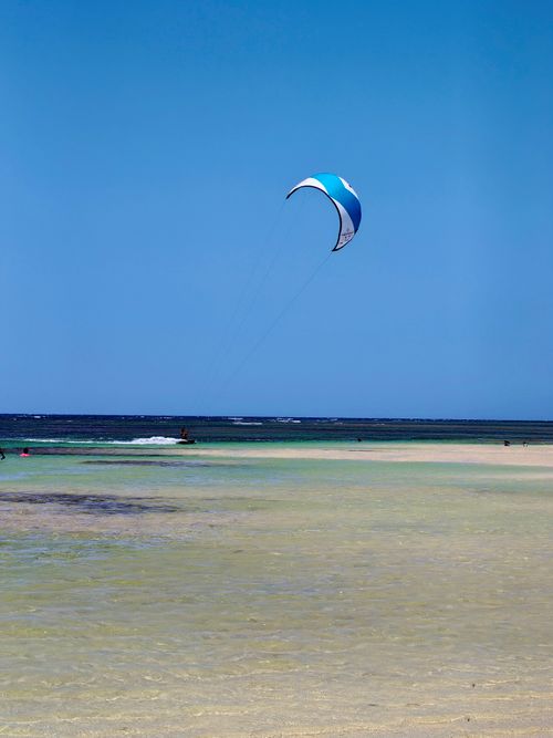 Free A vibrant scene of kitesurfing over the turquoise waters of Samaná, Dominican Republic. Stock Photo