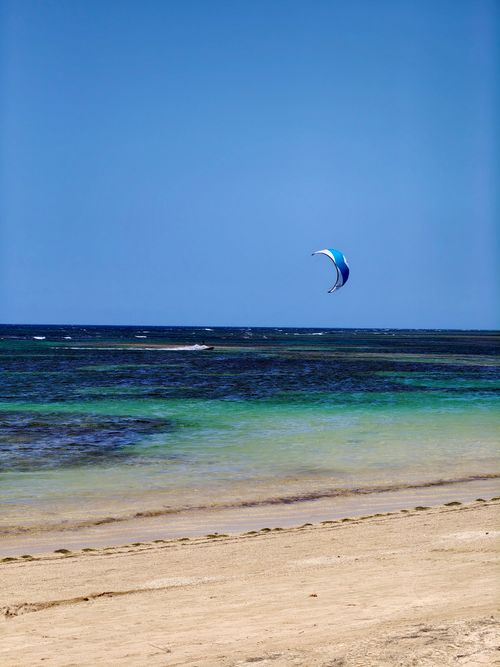 Free A vibrant kite surfing scene on a pristine beach in Samaná, Dominican Republic. Stock Photo
