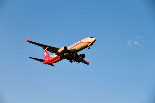 Free Airplane flying in clear blue sky, ideal for travel and aviation-themed content. Stock Photo