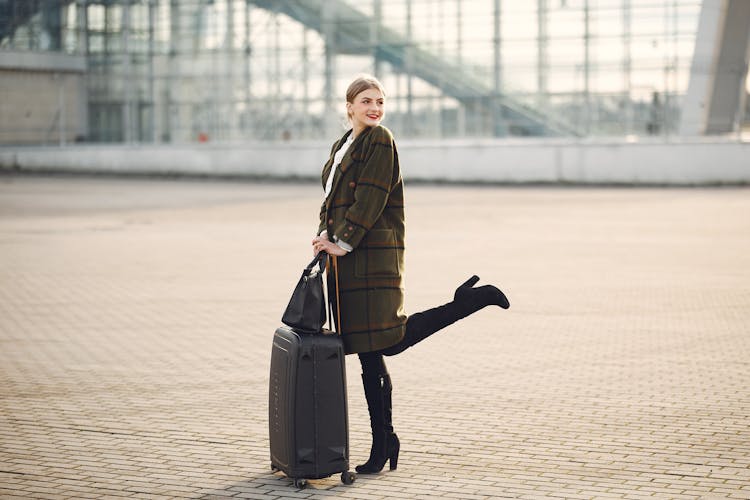 Elegant Lady With Baggage And Bag Next To Airport