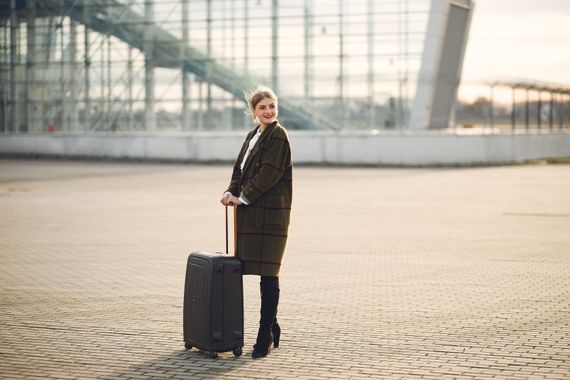Woman at a modern travel terminal with luggage
