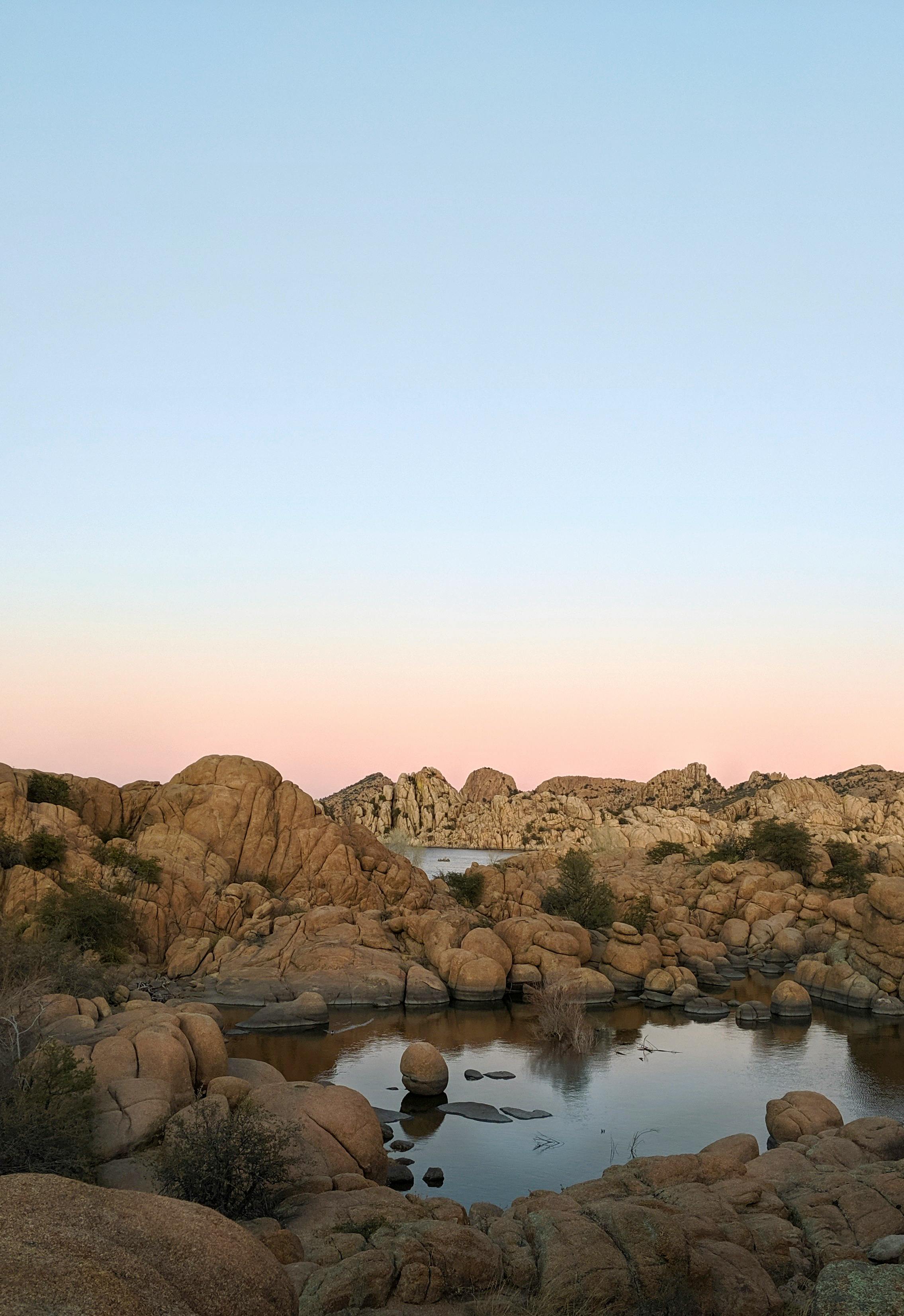 Beautiful sunset view of rock formations and calm waters at Watson Lake, Prescott, Arizona.