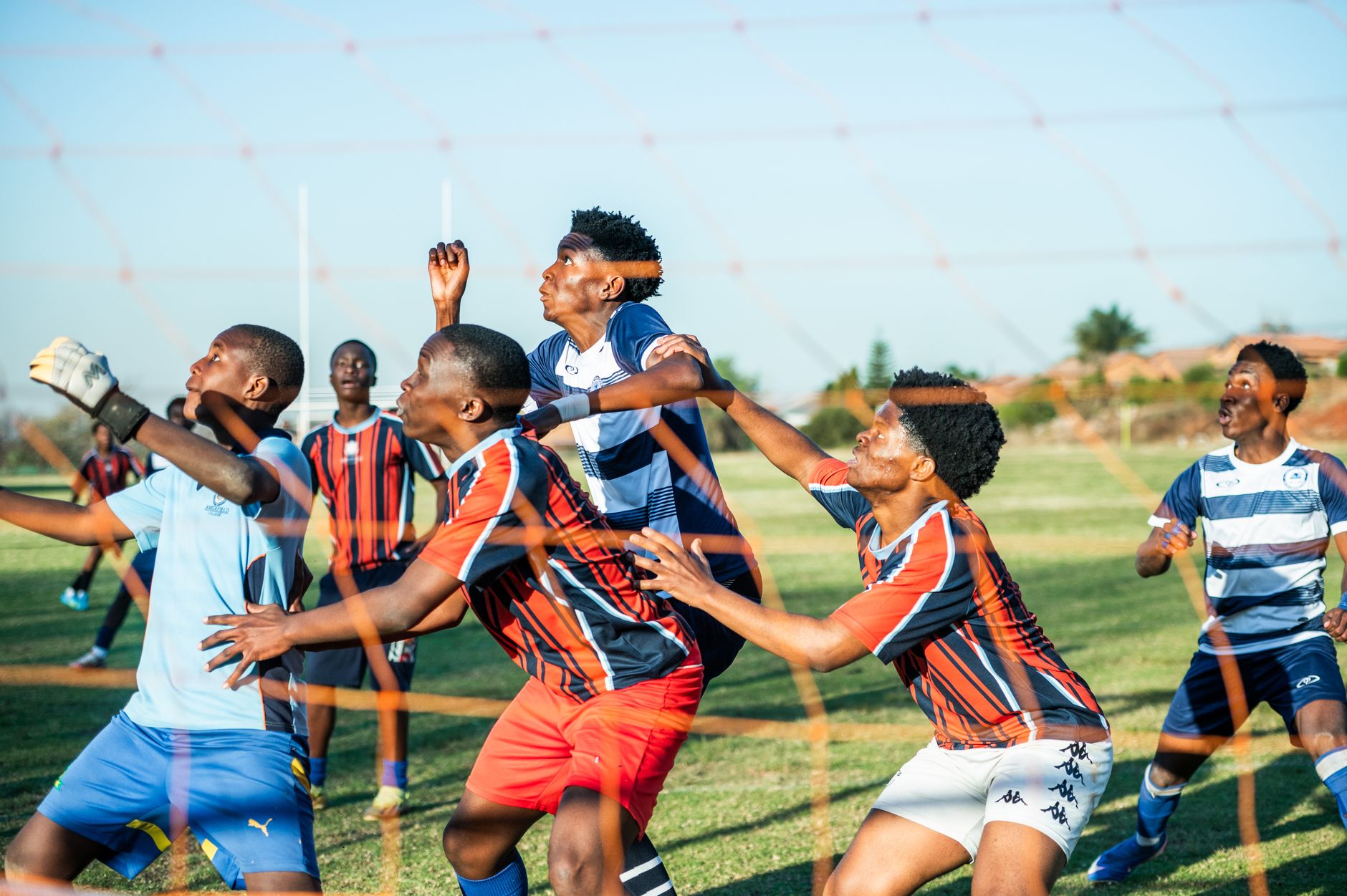 Young athletes engaged in a lively outdoor soccer match, showcasing skill and teamwork on the field.